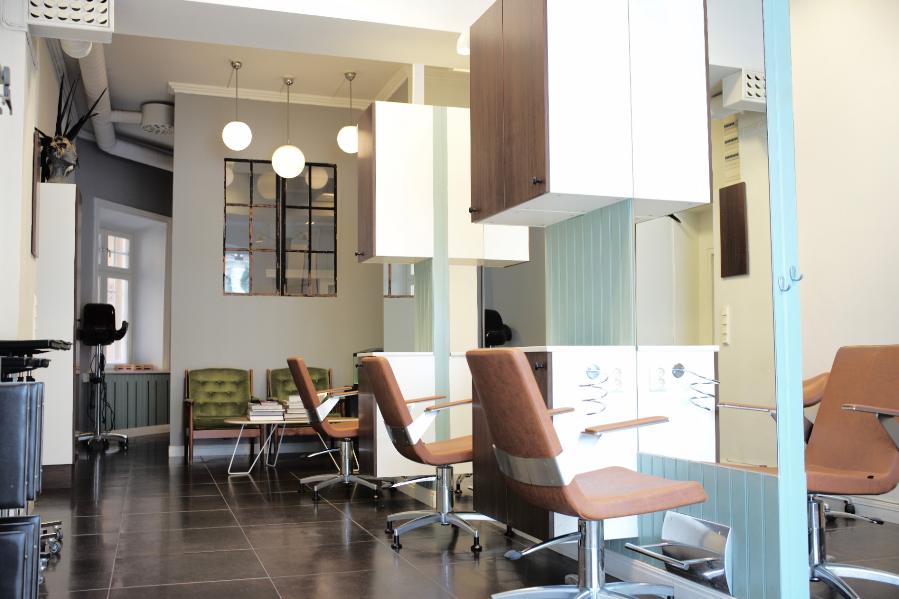Salon stations with green lounge chairs