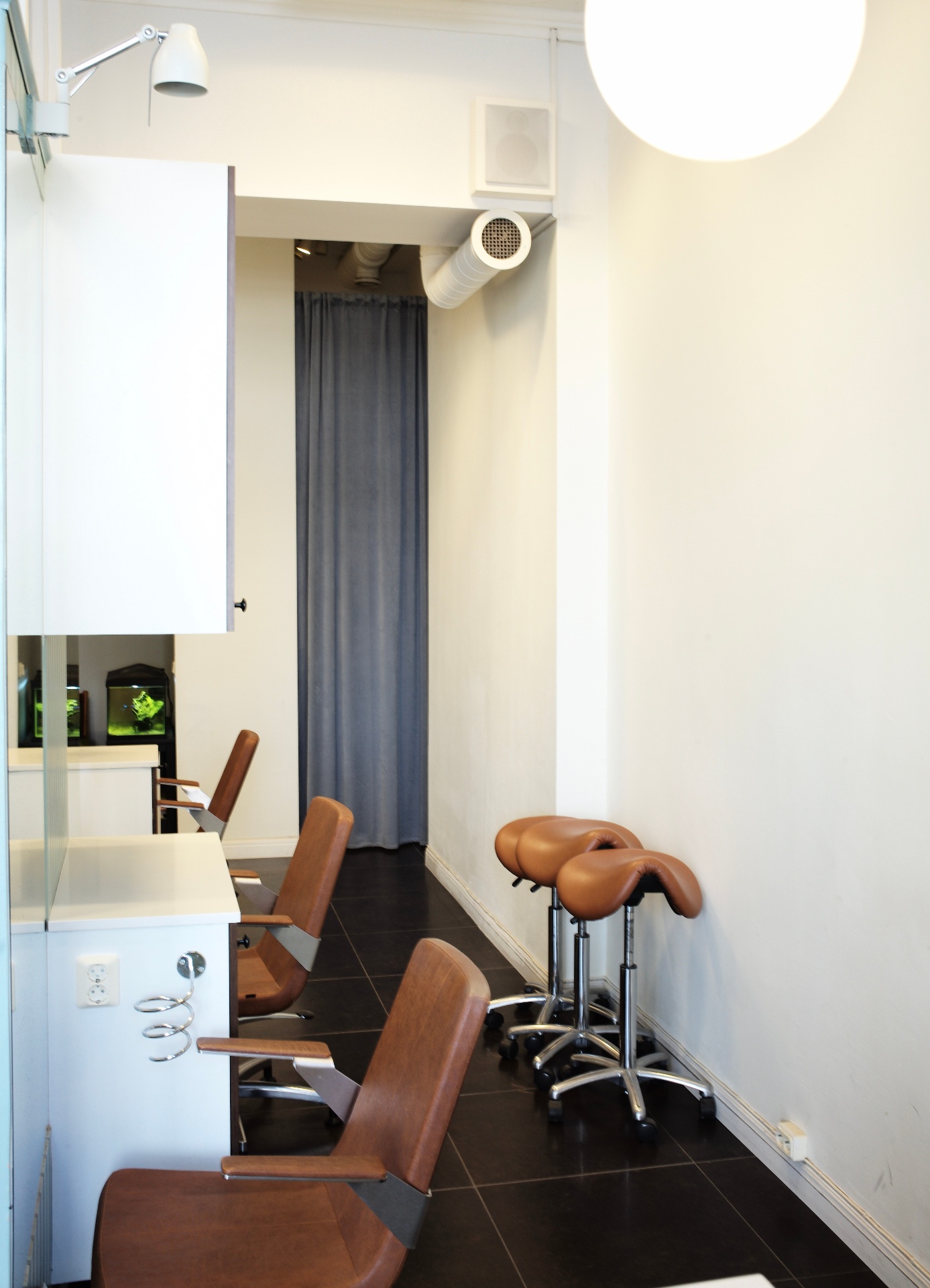 Side row of styling stations and stools